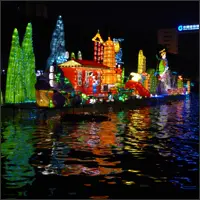 Colorful illuminated inflatables decorating Guilin's riverfront at night.