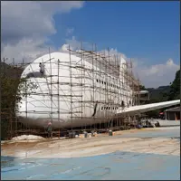 Airplane-shaped building under construction within the park.